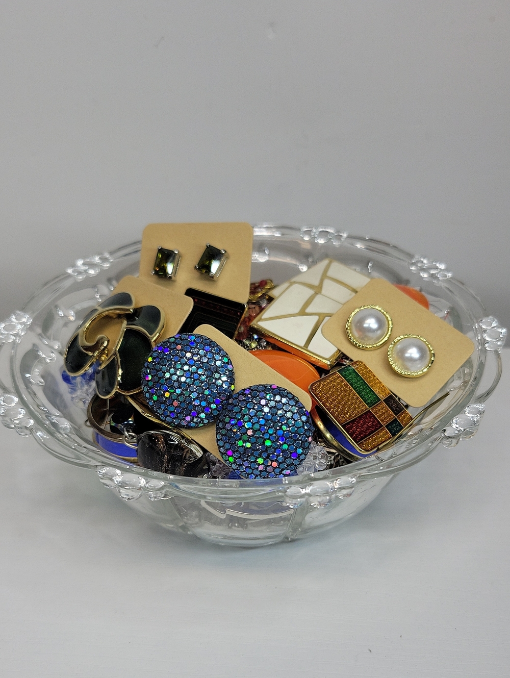 Assorted Earrings In A Glass Bowl